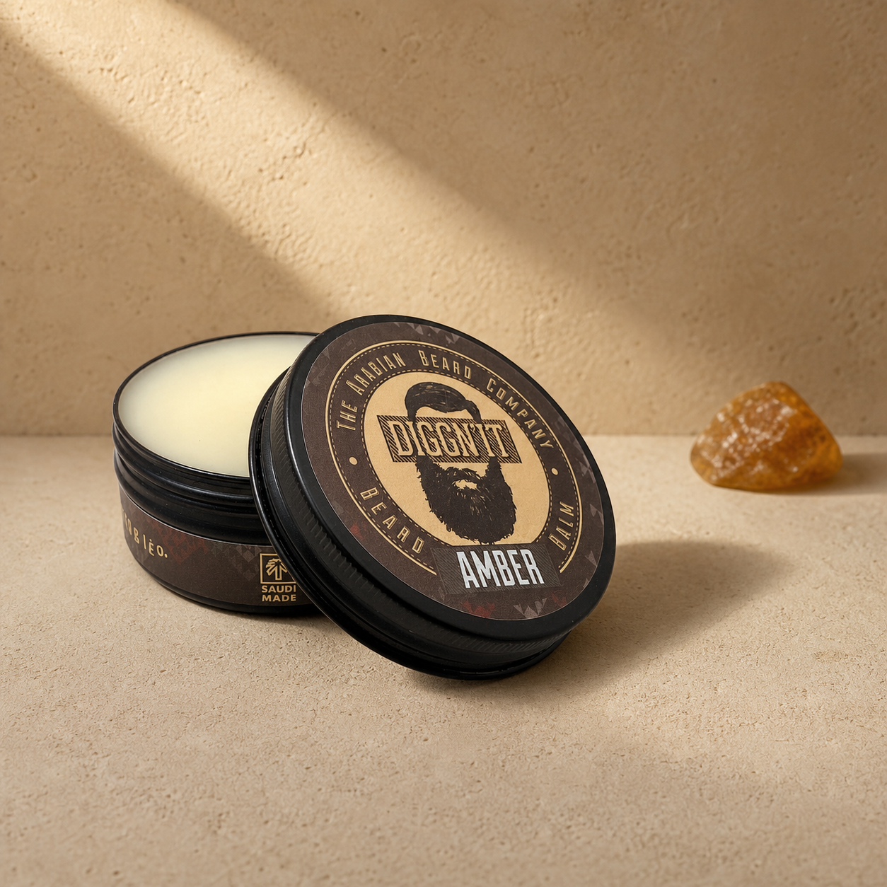 Diggn'It Amber Arabian Beard Balm open tin on a warm amber mineral surface