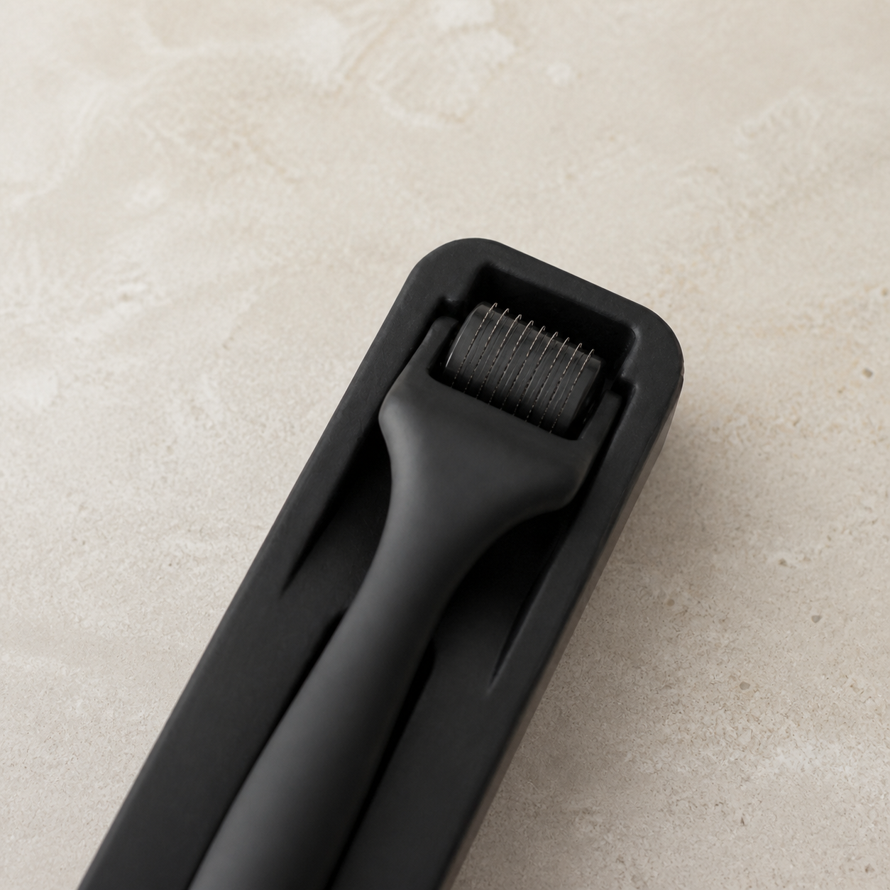 Close-up of the Diggn'It Derma Roller head showing its fine 0.30 mm needle scale