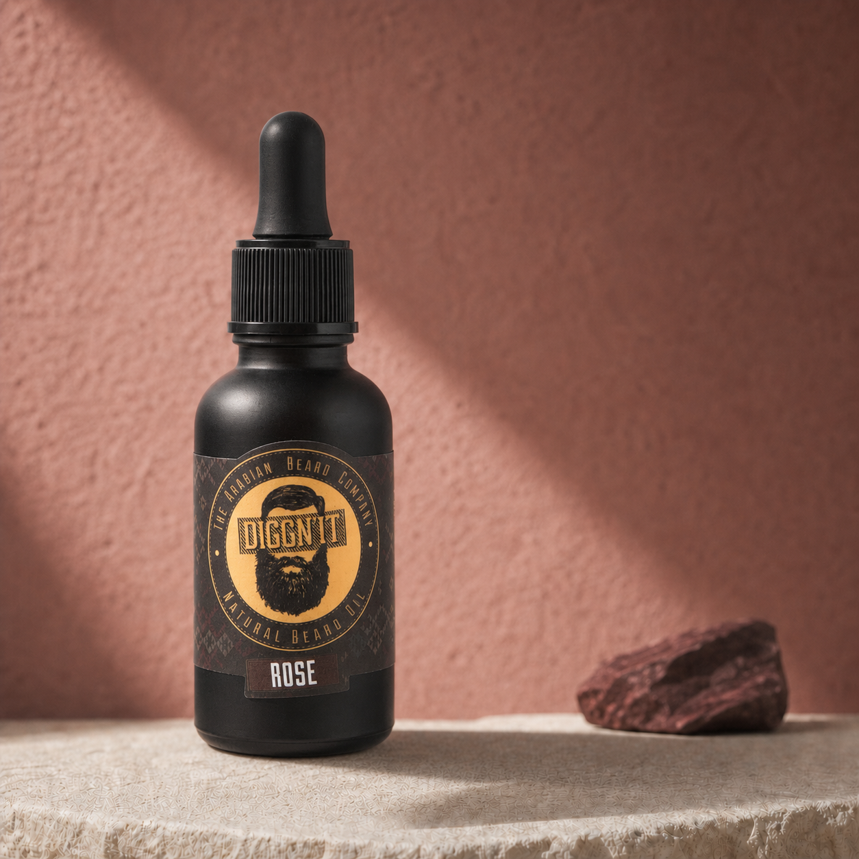Diggn'It Rose Arabian Beard Oil bottle on a dusty rose mineral backdrop