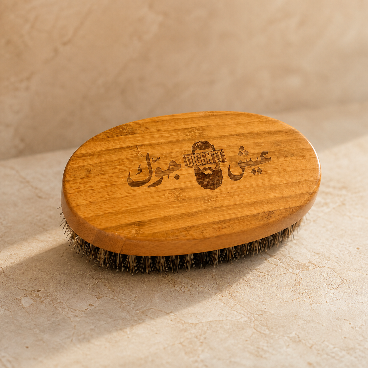 Diggn'It Bamboo Beard Brush on a warm ivory mineral surface