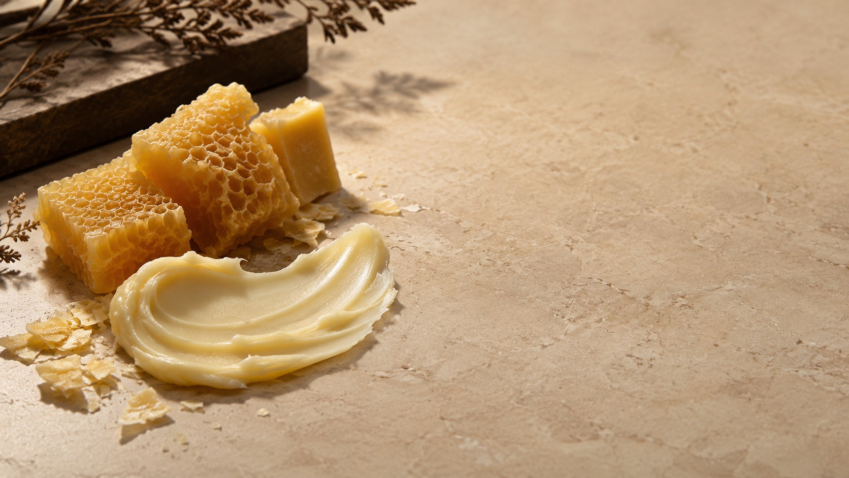 Beeswax, wax flakes, and creamy balm texture on stone