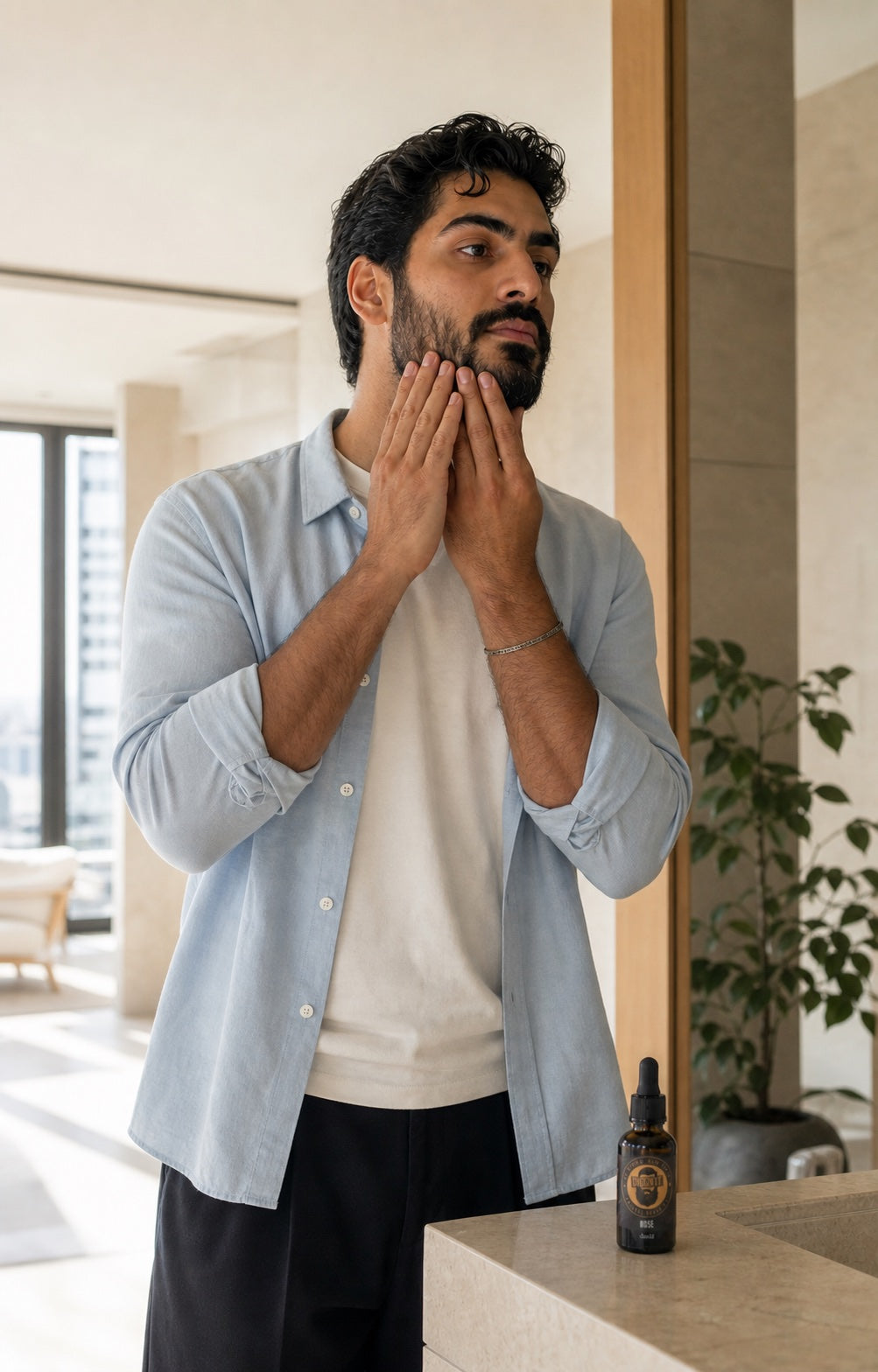 A man applying Rose Arabian Beard Oil before a lighter social occasion